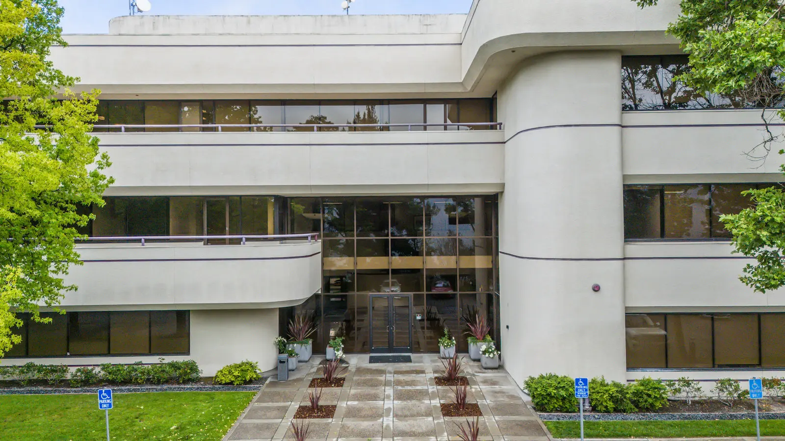 The glass lobby entrance of 3235 Kifer Rd in Santa Clara from the air