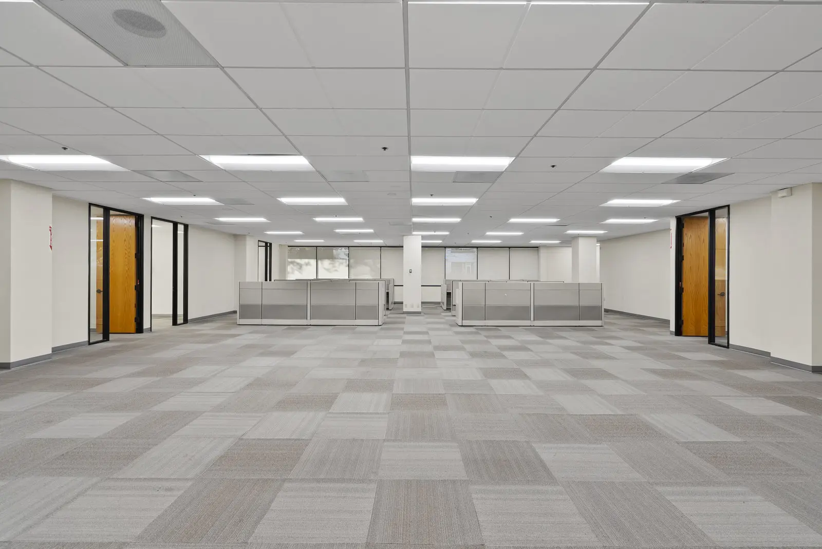 The open office floor of Suite 260 at 3235 Kifer Rd in Santa Clara, with glass-front offices along one wall